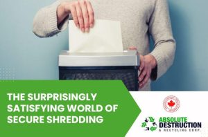 This image features a person inserting a sheet of paper into a shredder, emphasizing secure document disposal. The bold green banner highlights the text, "The Surprisingly Satisfying World of Secure Shredding," alongside the logo for Absolute Destruction & Recycling Corp.